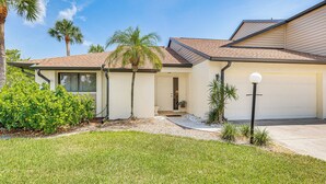 A residential house with a front yard, palm trees, and a garage. - 5 Mi to Fort Myers Beach: Home w/ Large Yard! (Fort Myers)