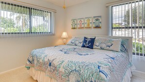 A bedroom with a large bed, a ceiling fan, and a window with bars. - 5 Mi to Fort Myers Beach: Home w/ Large Yard! (Fort Myers)