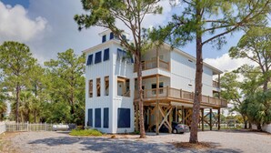 A two-story building with a wooden deck and a covered area. - Bayfront Gem Near Fishing in Dauphin Island (Dauphin Island)