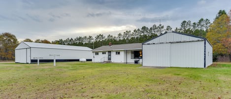 A large, single-story building with a flat roof and a small attached garage.