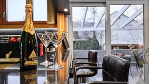A bottle of Kupferberg Trocken on a bar counter with two martini glasses. - Holiday Home 'Am Millibach' with Private Terrace, Private Garden and Wi-Fi (Wehingen)