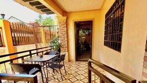 An outdoor patio area with a patterned tile floor, metal railings, and a seating arrangement. - Len's Staycation 3bdr-2br-downstairs ,netflix&wifi (Davao)