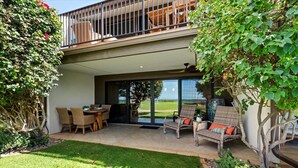A covered patio with outdoor furniture, a dining area, and a view of the ocean. - Maalaea Surf C2 1 Bedroom Condo (Kihei)