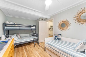 A compact room with bunk beds, a sofa, and a small table. - 3Bdrm, Pool/Spa, private oasis (Indian Rocks Beach)