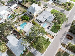 A residential property with a swimming pool, multiple outdoor seating areas, and a well-maintained lawn. - 3Bdrm, Pool/Spa, private oasis (Indian Rocks Beach)