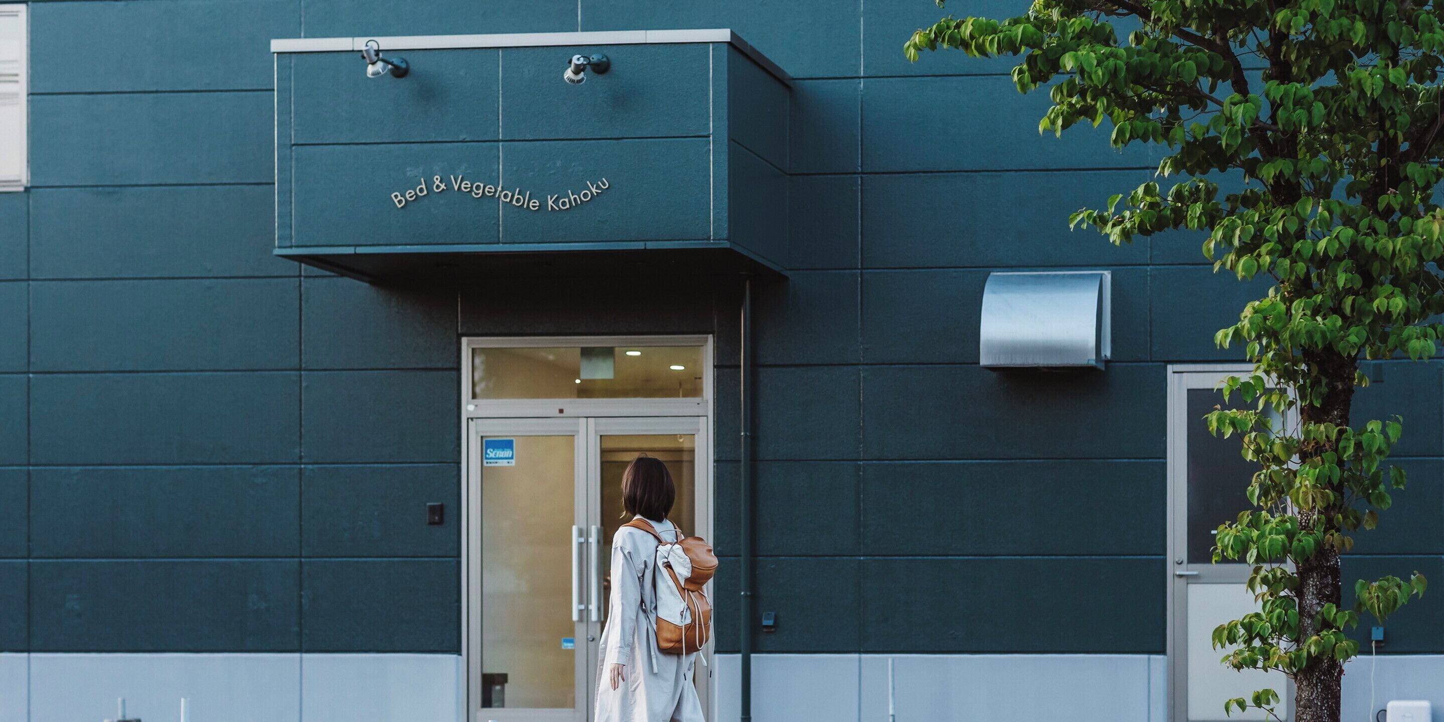 A building with a sign reading 'Bed & Vegetable Kahoku' above the entrance.