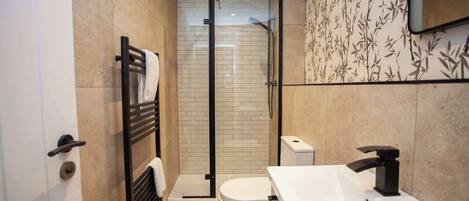 Shower, hair dryer, towels, shampoo