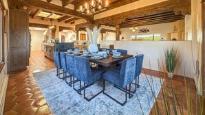 A spacious dining area with a wooden ceiling and a large table set for six. - Indoor Pool and Pickleball Estate (Santa Fe)