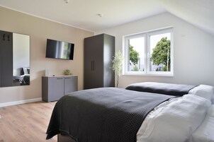 Apartamento premium, 2 camas de solteiro | Wi-Fi de cortesia, roupa de cama