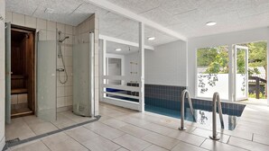 A modern bathroom with a glass shower enclosure, a built-in bathtub, and a view of the outdoors. - Beautiful Home In Ebeltoft With Sauna (Ebeltoft)