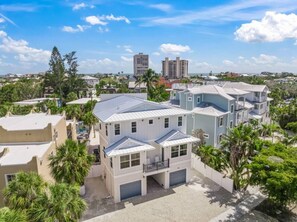 A two-story house with a flat roof, a garage, and a balcony.