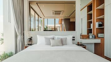 A modern bedroom with a large bed, a built-in wardrobe, and a view of the outdoors.