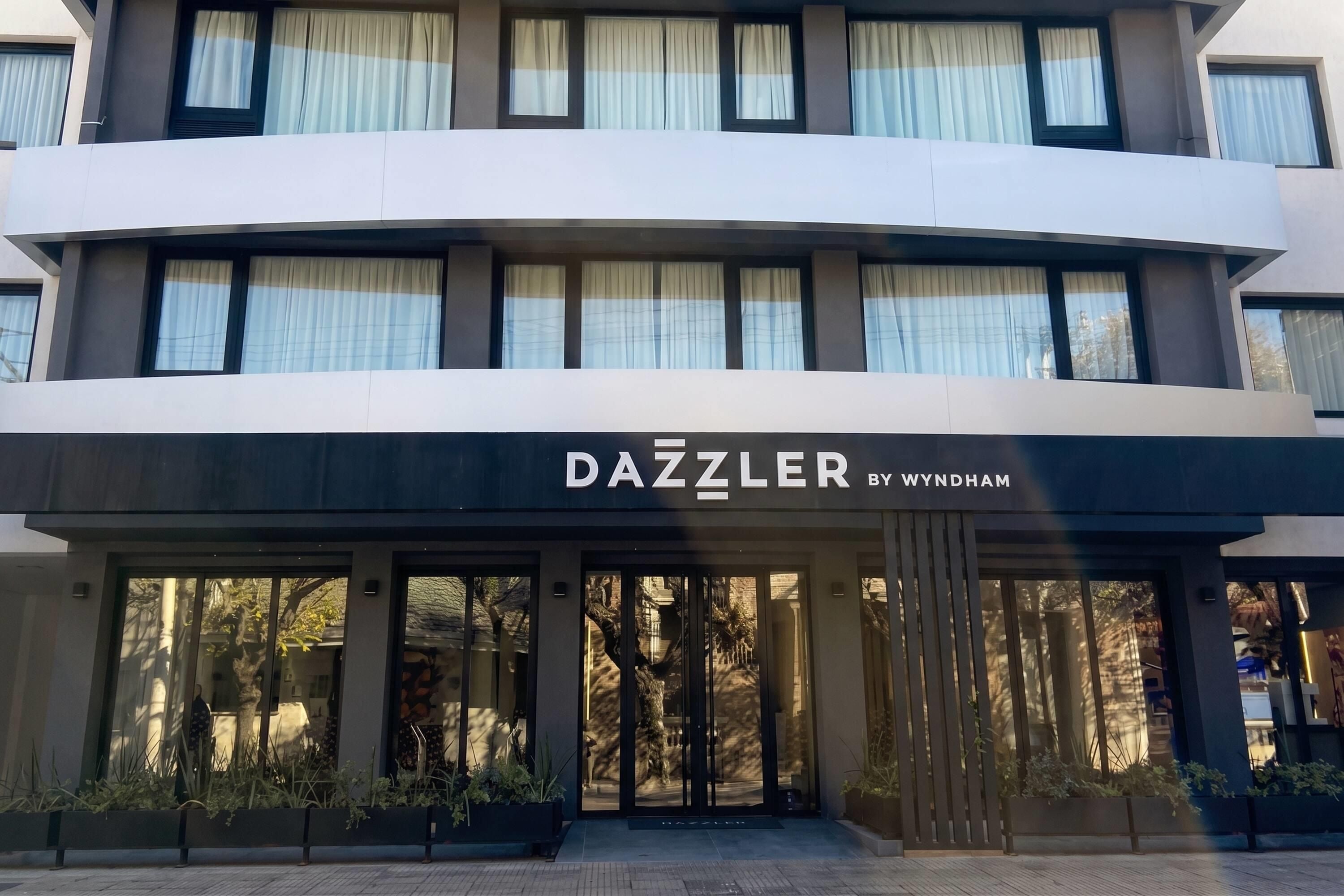 A building with a sign reading 'DAZZLER BY WYNDHAM' above the entrance.