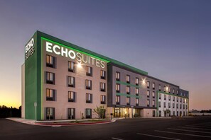 A modern hotel building with the name "Echo Suites" prominently displayed. It features a multi-story structure with a flat roof and a series of windows on each floor. - Echo Suites Extended Stay By Wyndham Phoenix-Peoria/Glendale (Peoria)