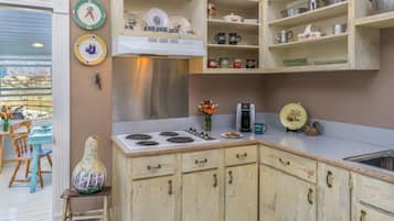 Fridge, coffee/tea maker, cookware/dishes/utensils, dining tables