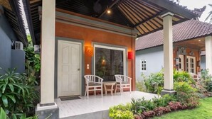 A house with a covered porch, a door, and a window. - Utama Villas Beach Front Candidasa (Bali)