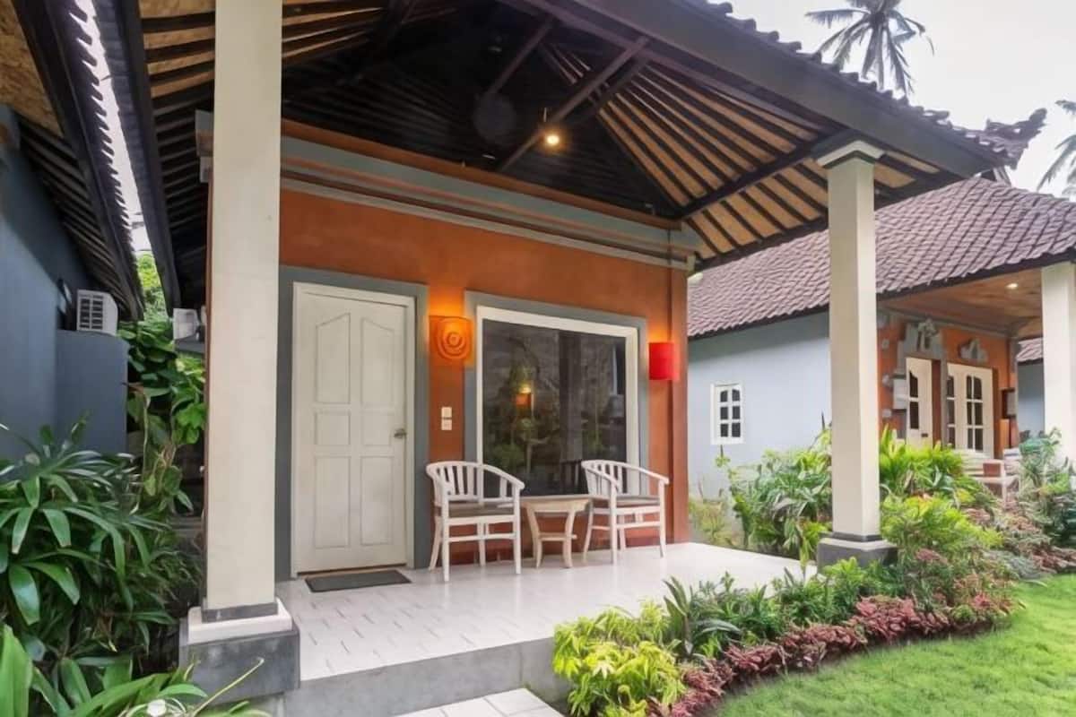 A house with a covered porch, a door, and a window.