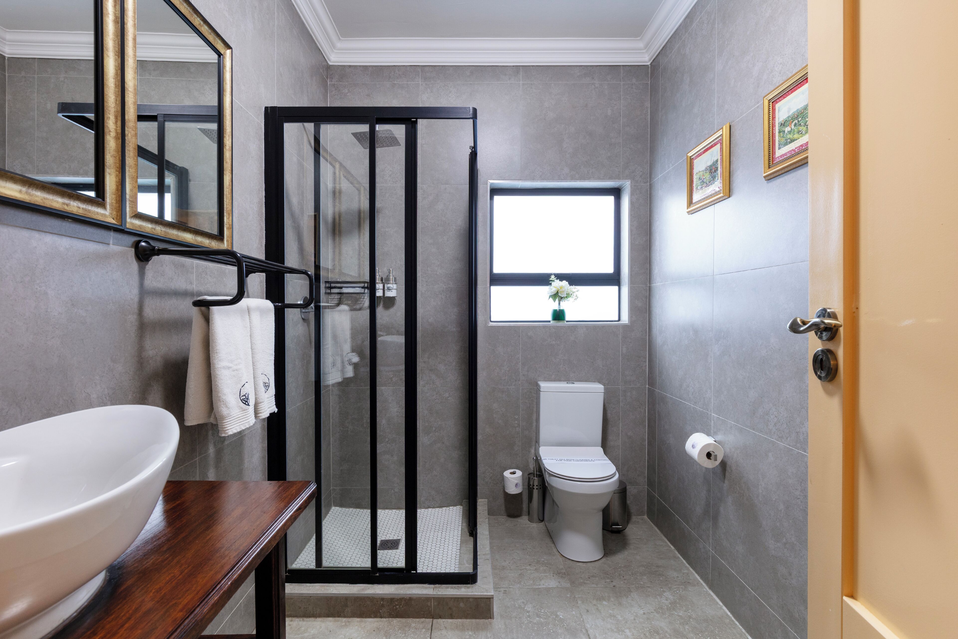 A bathroom with a shower, toilet, and sink.