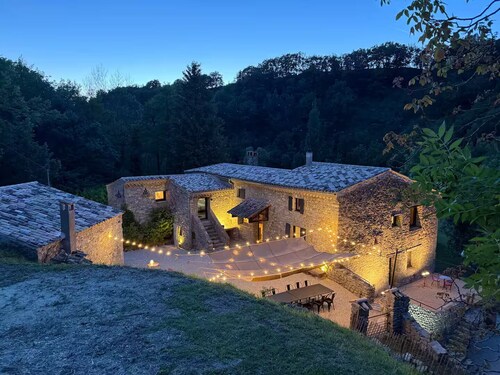 Old mill nestled in greenery in Drôme Provençale, hidden from view