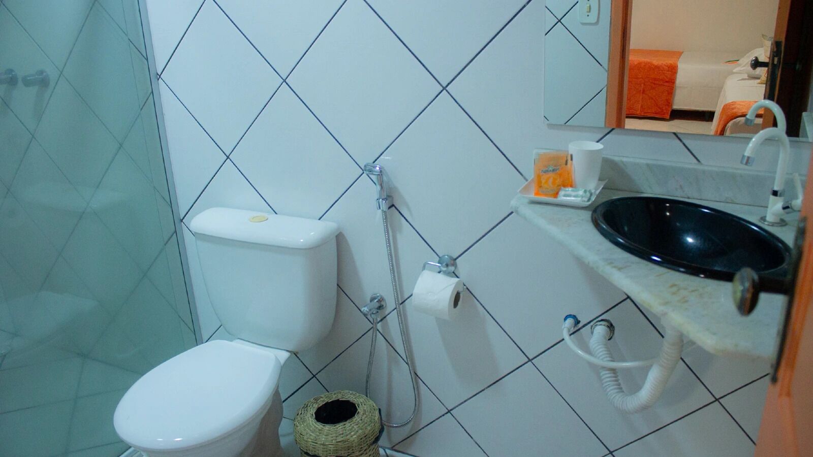Een badkamer met toilet, bidet en wastafel.