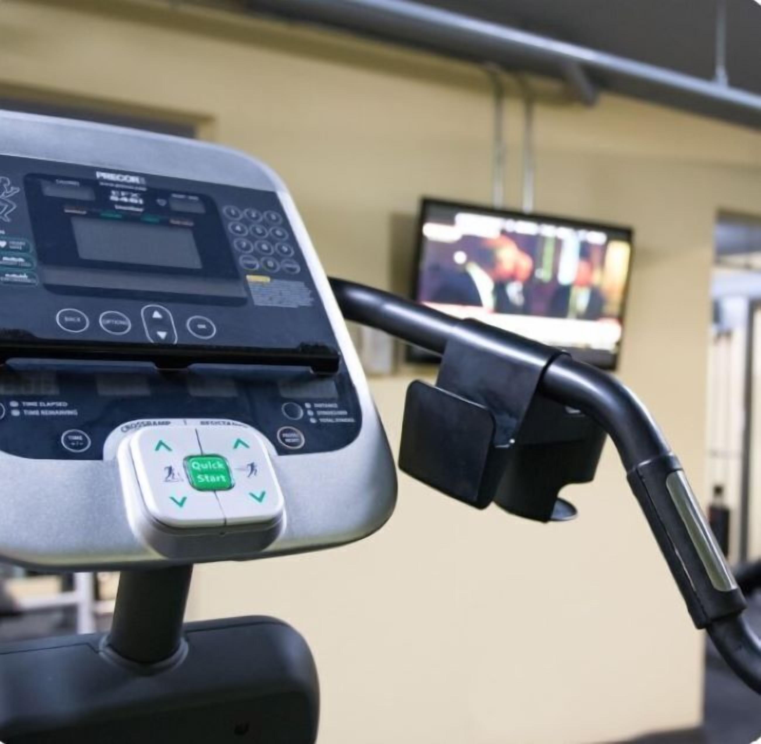 A treadmill with a digital display and a 'Quick Start' button.