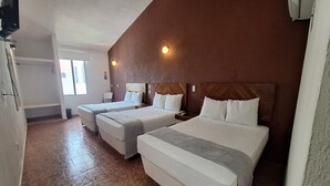 A hotel room with two beds, a window, and a wall-mounted TV. - Hotel Rolovi Cancun (Cancun)