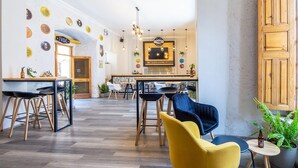 A spacious interior with a bar area, wooden furniture, and decorative plates on the walls. - Hotel Mosna (Arequipa)