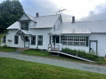 Front of house. The ramp leads you to the front porch and then into the kitchen.