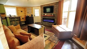 A cozy living room with a sofa, a coffee table, and a fireplace.