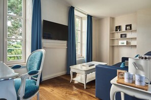 Un salon moderne comprenant un téléviseur, un canapé, une table à manger et une table basse.