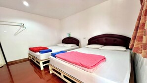 A hotel room with two beds, each with a headboard, and a wooden floor. - Chalalai Resort Kham Chanot By Zuzu (Ban Dung)
