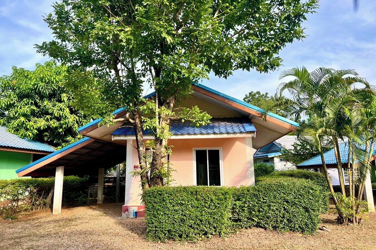 A single-story building with a blue roof and a covered porch.
