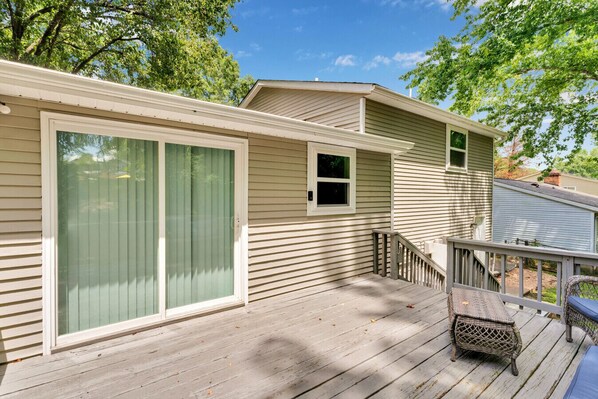 A single-story mobile home with a covered deck, sliding glass doors, and a small window. - Game Room + Deck | 3BR Home Sleeps 7 | Charlotte (Charlotte)