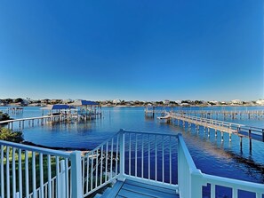 A waterfront property with multiple docks and a wooden deck.