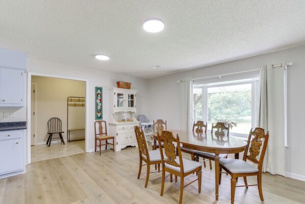 A dining area with a round table, wooden chairs, and a white cabinet. - 7 Mi to Tennessee River: Home w/ Patio in Florence (Florence)