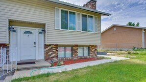 A two-story house with a front porch, a garage, and a brick foundation. - 12 Mi to Temple Square: Cozy + Convenient Apt! (Taylorsville)
