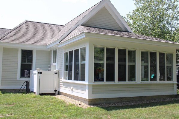A two-story house with a covered porch and a small attached garage.