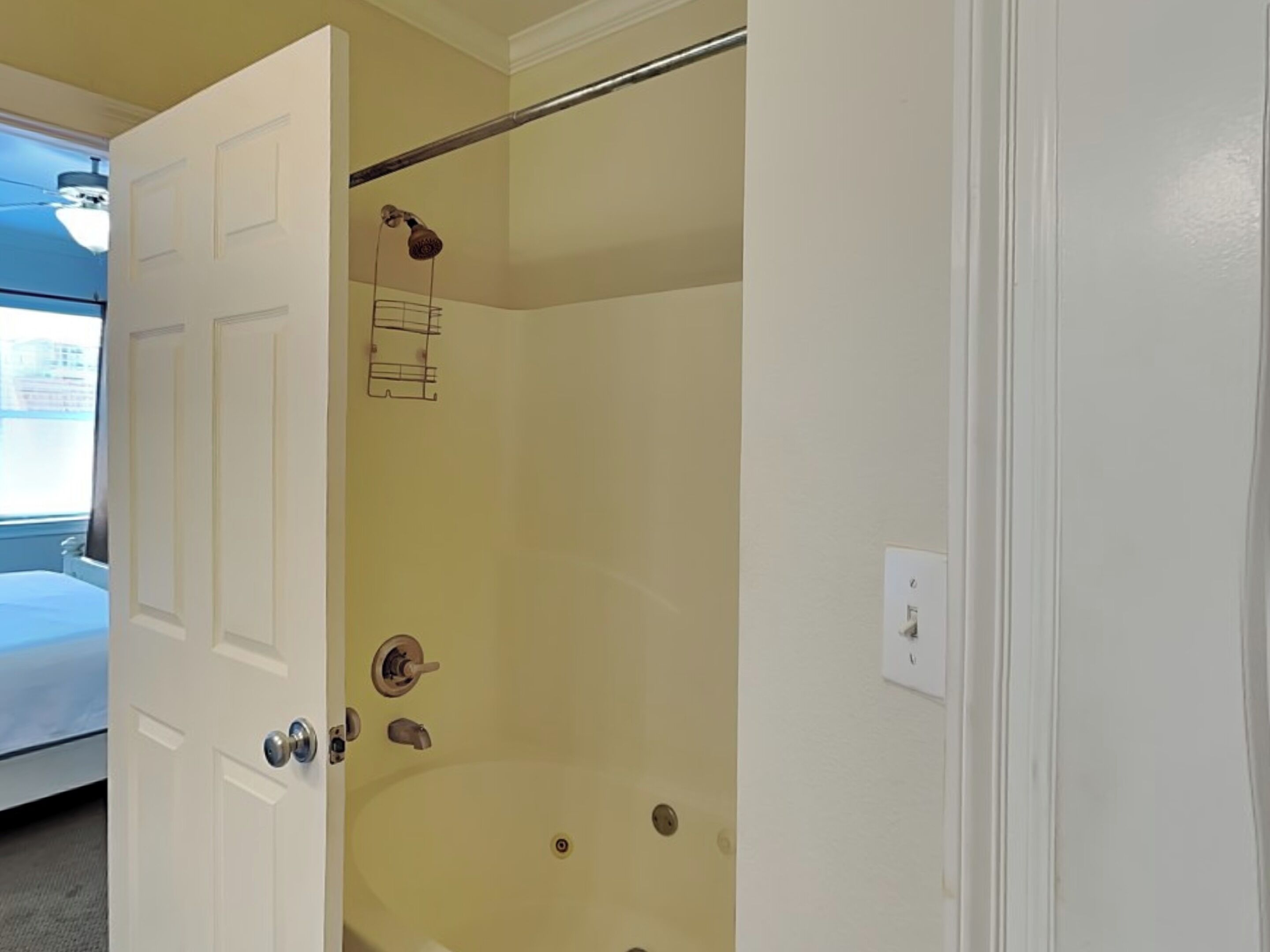 A bathroom with a shower, a toilet, and a sink.