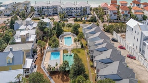 A resort with multiple buildings, a central pool, and a beach view. - Palms North #7B by Southern Vacation Rentals (Santa Rosa Beach)