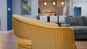A modern interior with a row of yellow upholstered chairs in a well-lit area.