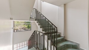 A staircase with a metal railing, leading to an upper floor. - Wenceslao By Homirent (Queretaro)