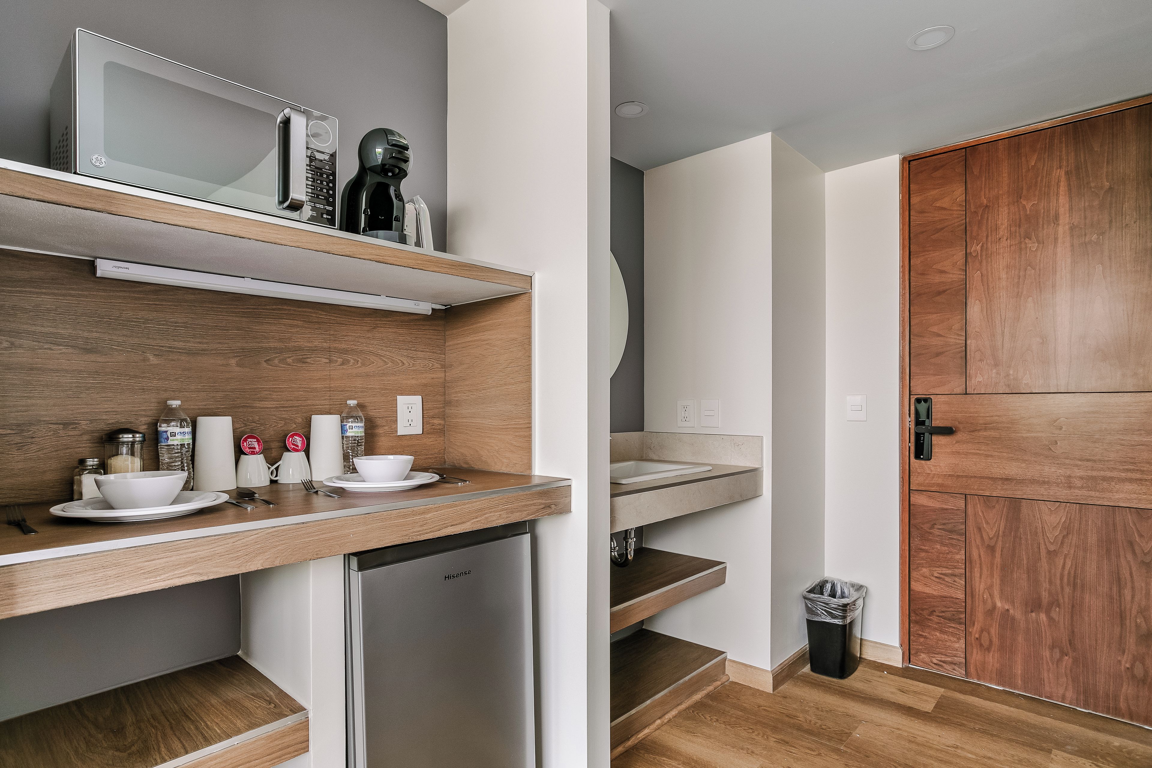 A modern kitchen with a built-in microwave, a coffee machine, and a dishwasher.