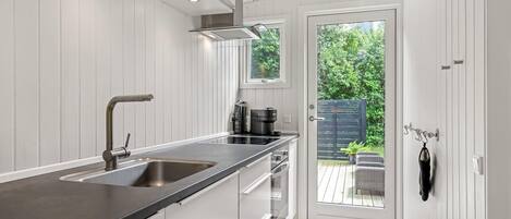 Fridge, stovetop, dishwasher, coffee/tea maker