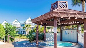 A covered outdoor area with a pool, wooden pergola, and a gated entrance. - Gulf Shores Plantation #4206 by Southern Vacation Rentals (Gulf Shores)