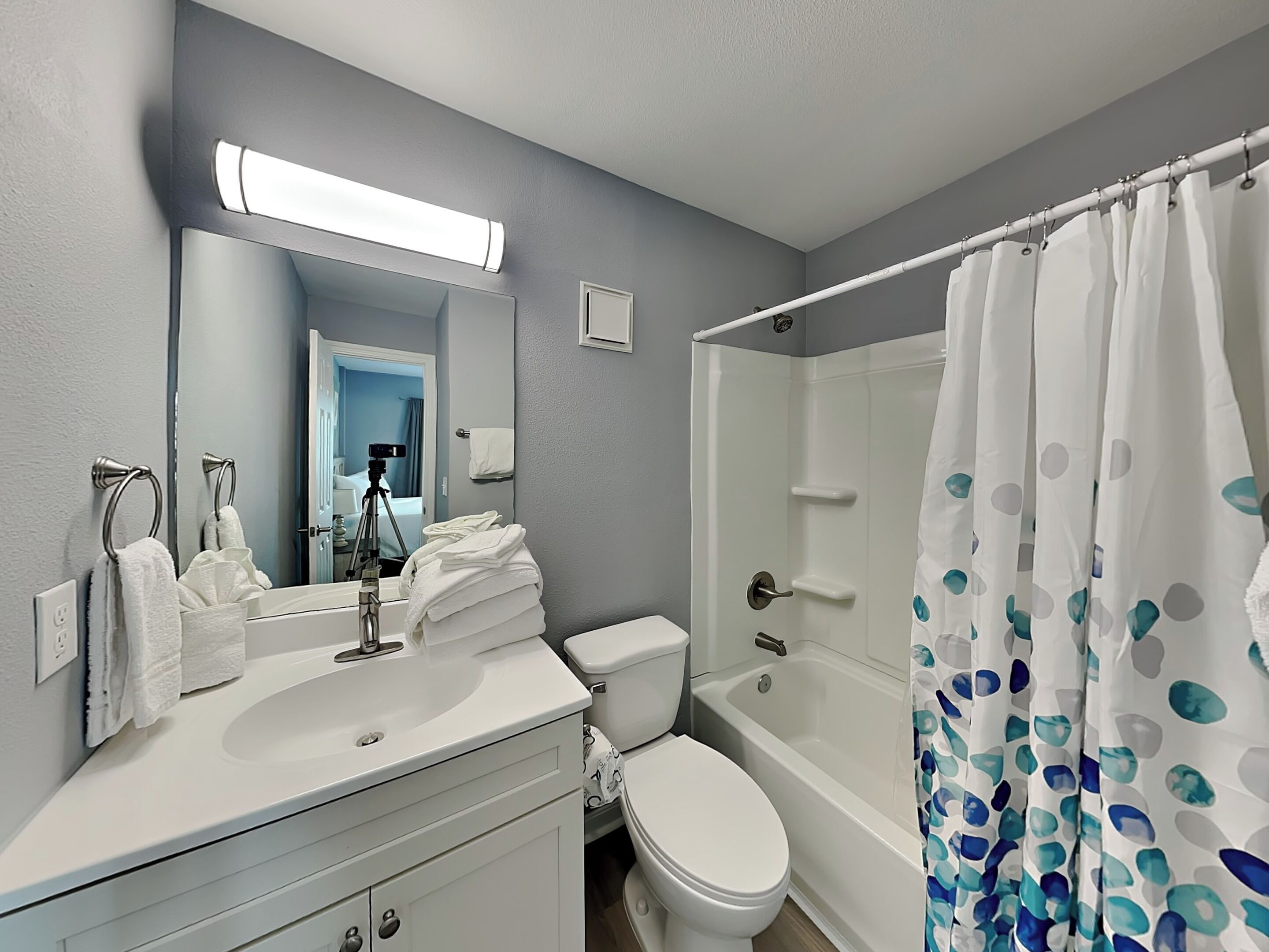 A bathroom with a sink, toilet, and bathtub.