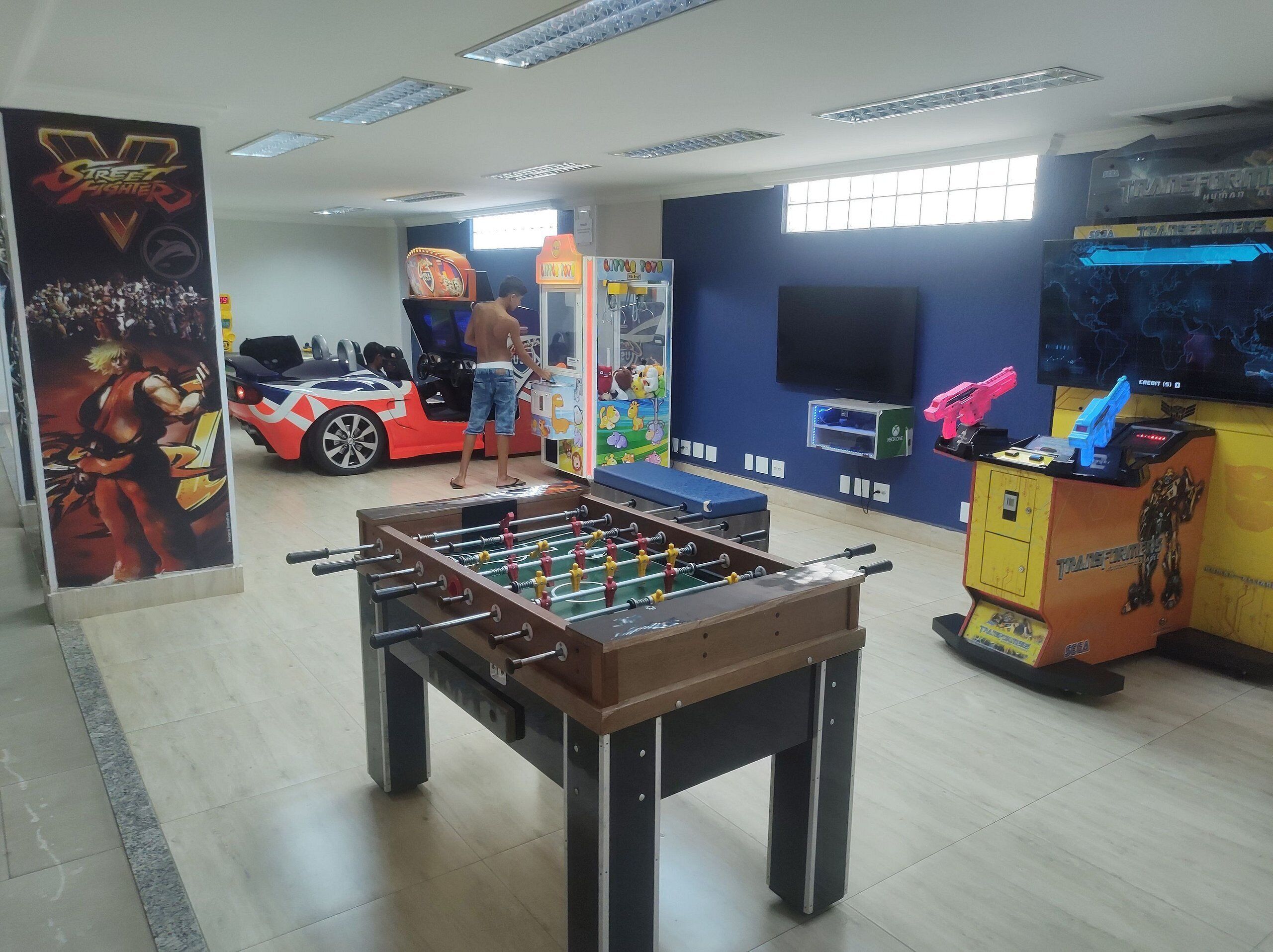 Ett rum med ett fotbollsspel, en arkadmaskin med bilspel och en arkadmaskin med Transformers-tema.