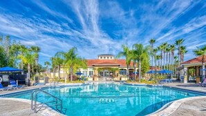 A swimming pool with a clear blue sky and palm trees. - Modern 3BR 2.5BTH Terra Verde Home with Private Hot Tub! (Kissimmee)
