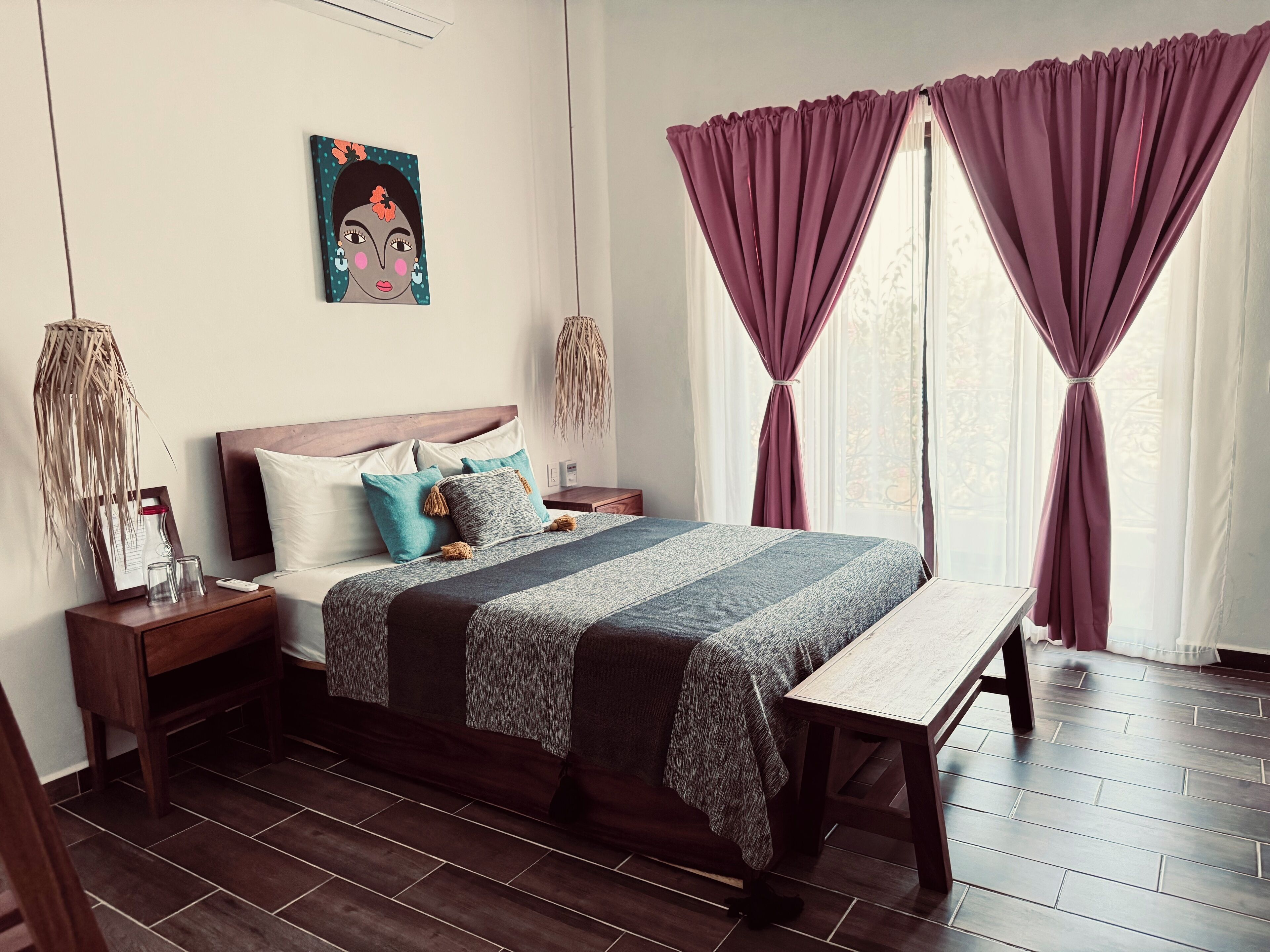 A neatly arranged bedroom with a wooden bed, a bedside table, and a bench.