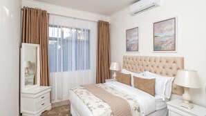 A bedroom with a large bed, a dresser, a mirror, and two wall-mounted lamps. - Stunning 3 Bedroom House Near Harare Airport -2297 (Harare)