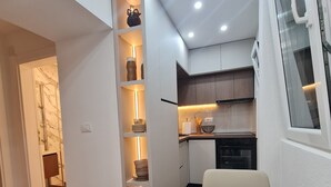 A modern kitchen with built-in cabinets, a marble countertop, and under-cabinet lighting. - Sea view Charming 1-bedroom apartment with AC, WiFi in enchanting Tivat (Tivat)